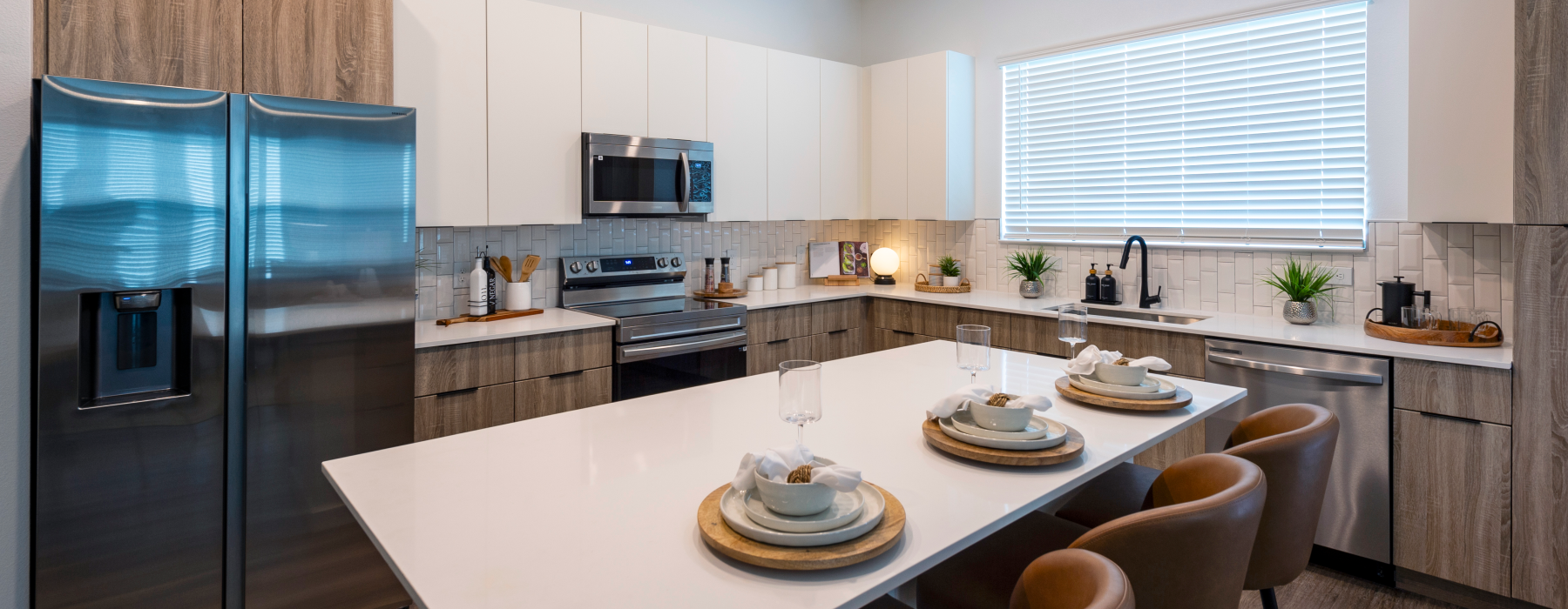 a kitchen with an island and chairs