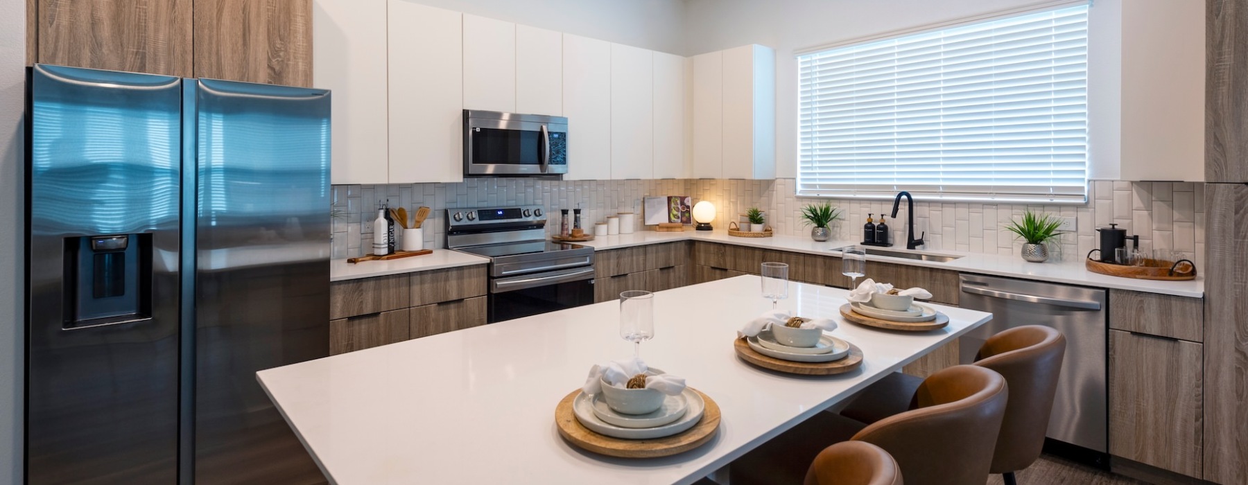 a kitchen with an island and chairs