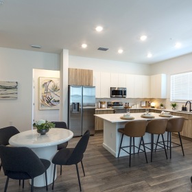 a kitchen with a dining table and chairs