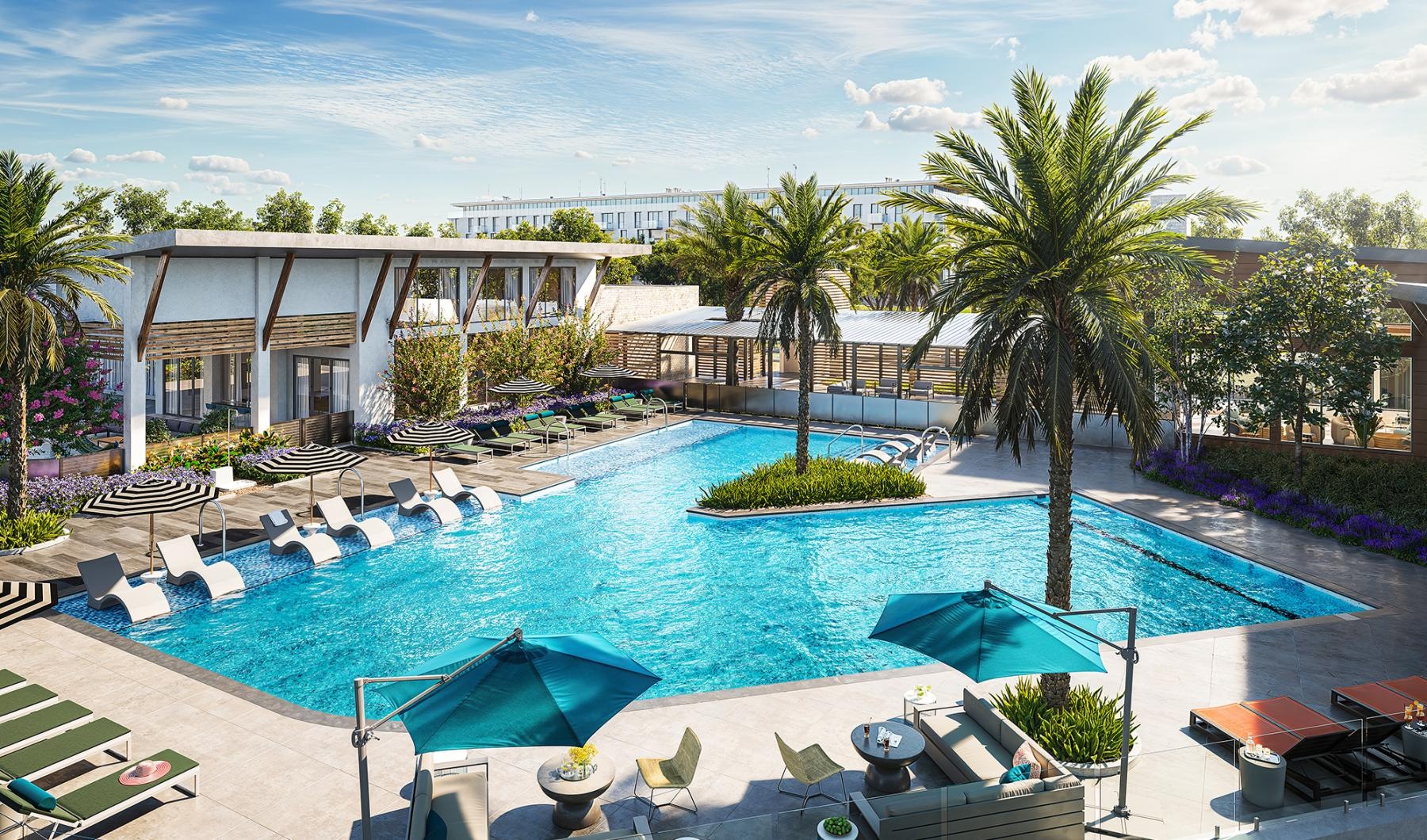 a pool with lounge chairs and umbrellas by a building