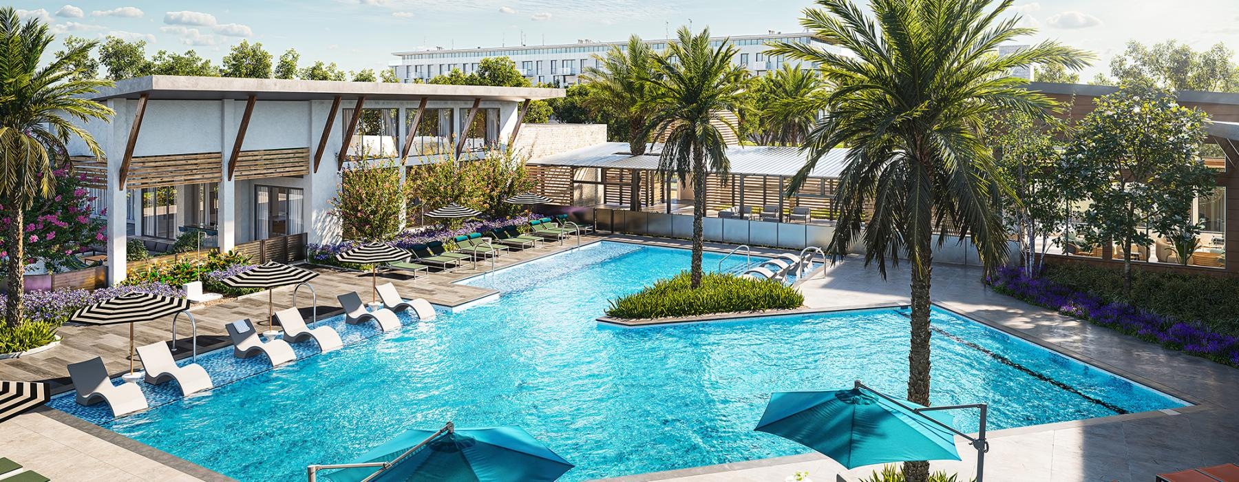 a pool with lounge chairs and umbrellas by a building